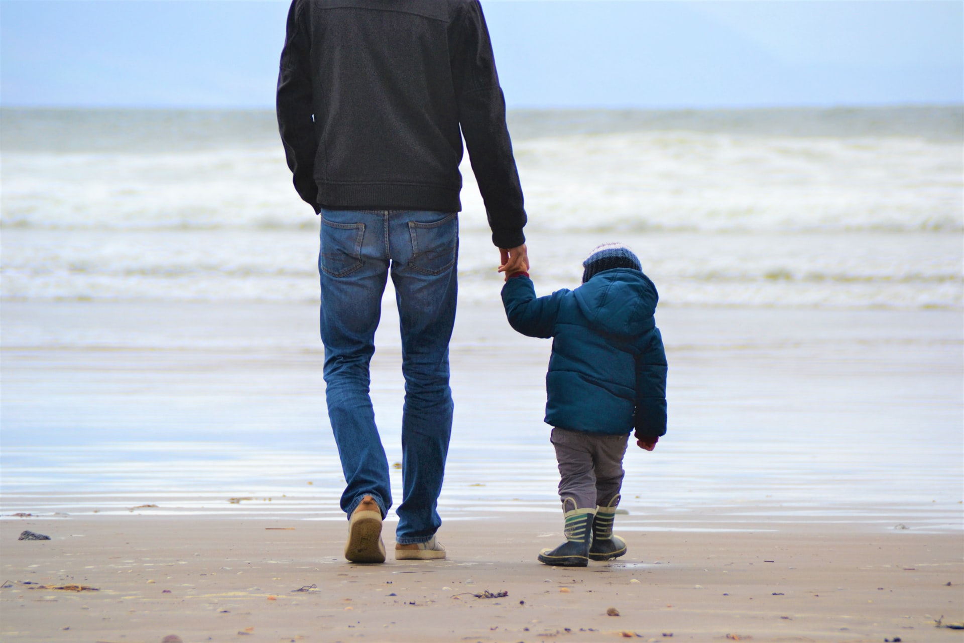 father and son walking on the beach